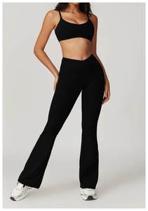 Detail showing high-waist yoga pants with a V-shaped cross waist and black sports bra
