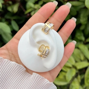 18k gold plated copper wave earrings with cubic zirconia stones on model