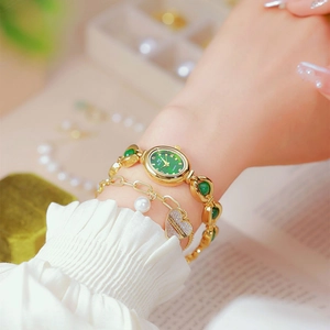 Elegant gold quartz watch with green oval dial and matching pearl heart bracelet set