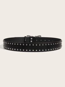 Detail of a black leather punk belt featuring double rows of silver metal rivets