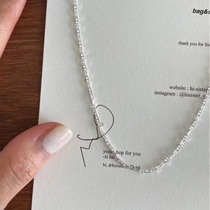 Close-up of minimalist 925 silver necklace with delicate rectangular link chain links