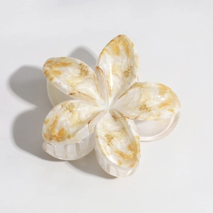Detailed macro view of plumeria hair claw clip with yellow marble texture finish