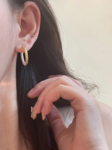 Minimalist gold and silver two-tone textured hoop earrings with hammered metal finish