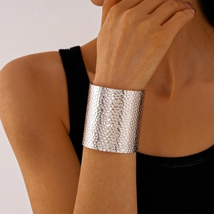 Detail of silver textured cuff bracelet with hammered metal finish on female wrist