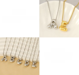 Detail view of gold and silver bubble letter pendants A-E in durable stainless steel