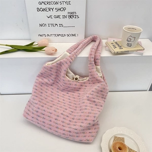 Detailed close-up of pink plush tote bag with colorful speckled texture and button closure