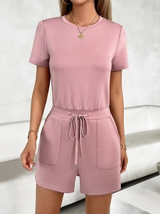 Detail of pink casual short jumpsuit with short sleeves, crew neck and waist drawstring