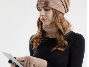 Detail of camel knit winter set showing touchscreen compatible gloves and warm beanie