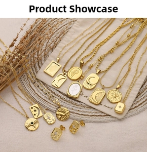 Detail shot of vintage gold-plated necklaces with relief pendants on linen