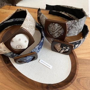 Detail of paisley fabric headbands with wooden buckles and anti-slip teeth design