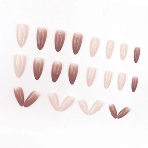 Brown gradient almond press-on nails with white leaf art and glitter finish