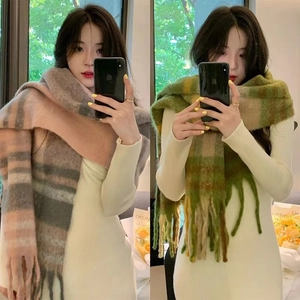 Close-up of rainbow plaid scarf texture with long fringe detail and warm mohair feel