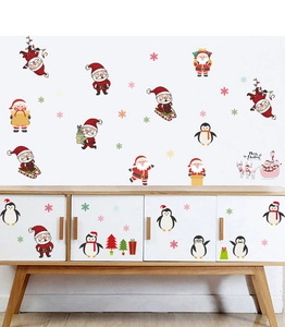 Cartoon Christmas wall stickers featuring Santa and penguins on white cabinet and wall surfaces