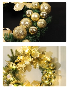 Detail of golden Christmas wreath with glitter balls, faux flowers and warm LED lights