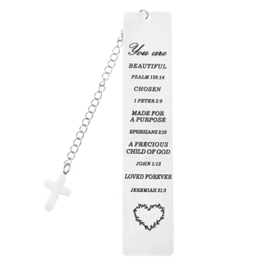 Macro shot of silver stainless steel bookmark with bible verses and cross charm detail