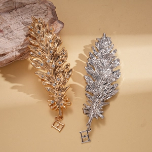 Vintage style gold and silver feather brooches with rhinestones and star pendants