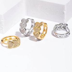Detail of stacked heart earrings with pavé zircons in gold and silver plating