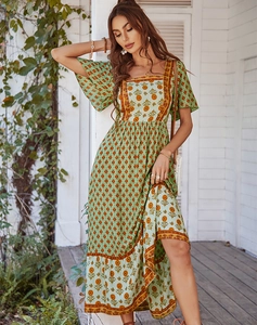Detail view of a green bohemian floral midi dress with square neck and ruffled hemline