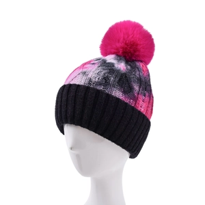 Women's winter tie-dye beanie with large pink faux fur pom and black ribbed cuff