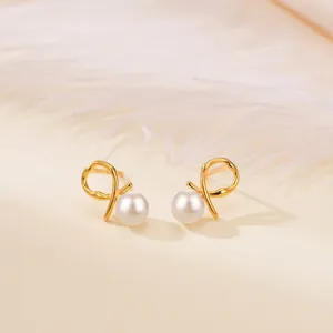 Elegant S925 silver pearl stud earrings with golden twist design on a white feather background
