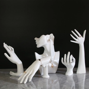 White resin jewelry display set with mannequin head and hand models on marble surface