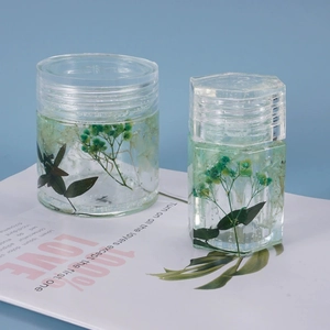 Detail view of cylindrical and hexagonal resin storage jars with botanical specimens