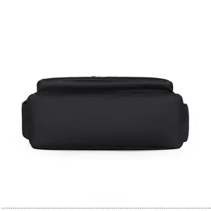 Detail view of the flat rectangular base with reinforced stitching on black nylon bag