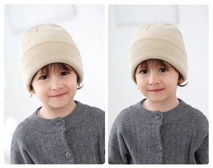 Detailed knit texture of a beige children's beanie with classic fold-over cuff design