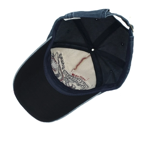 Detailed interior of dark blue denim shark baseball cap with sweatband and metal buckle