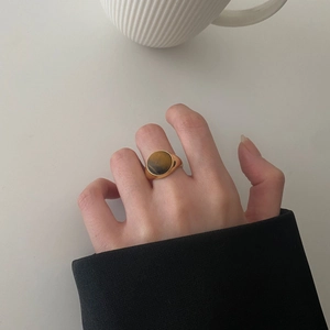 Minimalist gold S925 sterling silver ring with round tiger eye stone on finger
