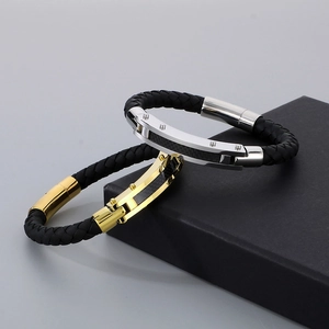 Detailed macro of men's braided leather bracelets with gold and silver metal accents