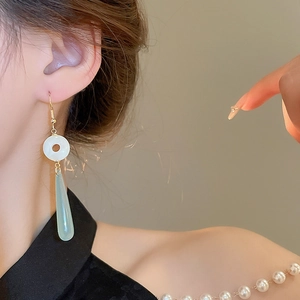 Elegant Chinese style resin jade teardrop earrings with gold hooks on female model