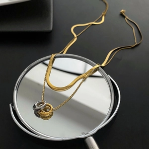 Elegant gold double layer snake chain necklace with interlocking gold and silver rings