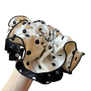 Elegant white polka dot satin scrunchie with black trim and vintage oversized design