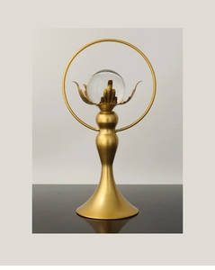 Detailed close-up of a luxury lotus crystal ball on a matte gold metal ring stand
