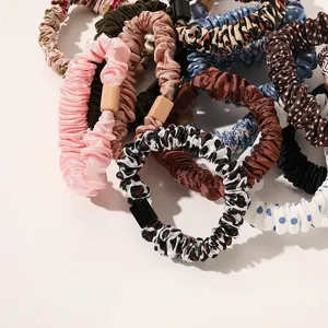 Detail view of colorful satin pleated scrunchies with elegant square resin buckle detail