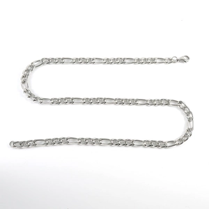 Macro detail of silver Figaro chain showing polished metal texture and lobster clasp