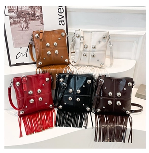 Detailed display of five color options for rivet messenger bags with long tassels
