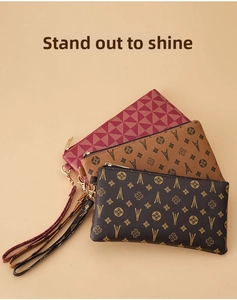 Three-piece set of vintage clutch bags with wrist straps in burgundy, camel, and coffee