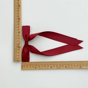 Burgundy double-layered satin bow hair clip with long ribbons on white background