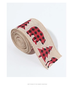Detail of Christmas burlap ribbon with printed bear and tree patterns on white background