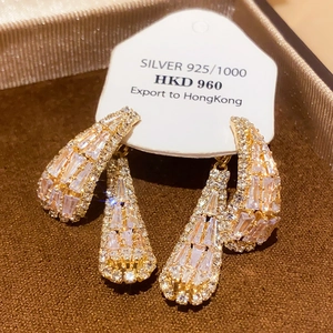 Detail of vintage bow pearl earrings with gold plating and sparkling zircon inlay