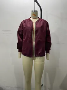 Detail of burgundy bomber jacket showing the ribbed cuffs and high-quality zipper closure