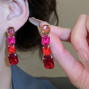 Detail of square gradient gemstone drop earrings in a claw setting on a model