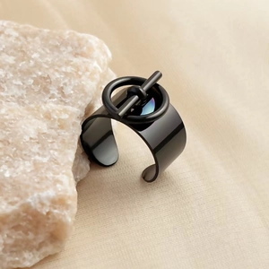 Detailed close-up of a wide gold-plated stainless steel ring with a unique ring and bar design