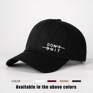 Adjustable black cotton baseball cap with DONT QUIT print shown in a studio setting