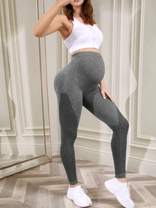 Macro detail of breathable honeycomb texture and high waist maternity support on yoga pants
