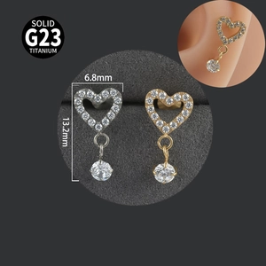 Macro detail of G23 titanium heart studs with dimensions and silver or gold finish