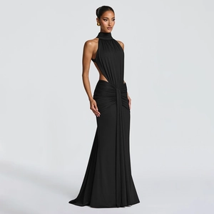Detail of elegant black backless evening gown with waist cutouts and floor-length fishtail hem