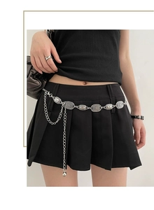 Detail of vintage silver adjustable metal waist chain with embossed oval plates